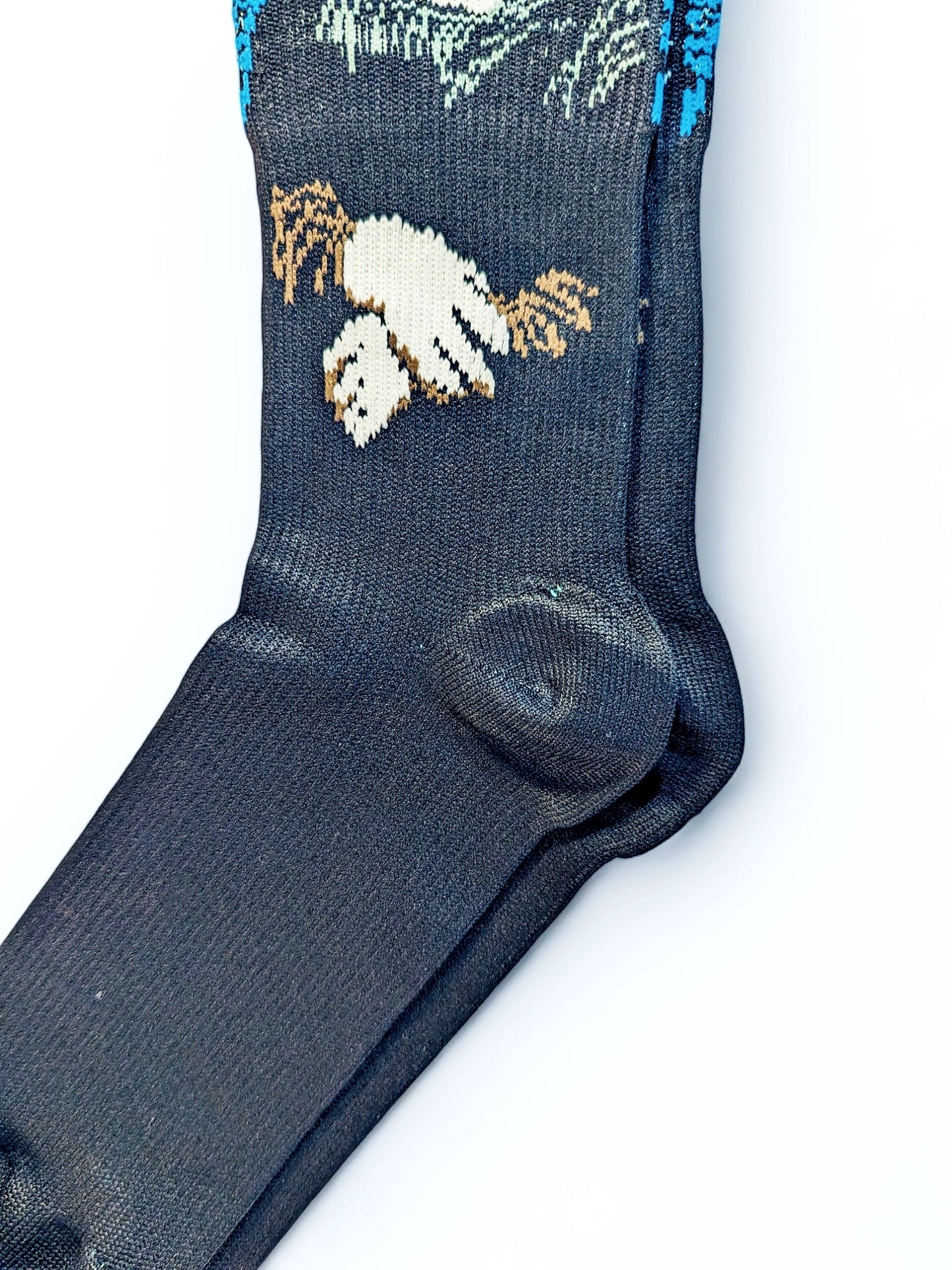 A pair of green Compression Socks, heel view