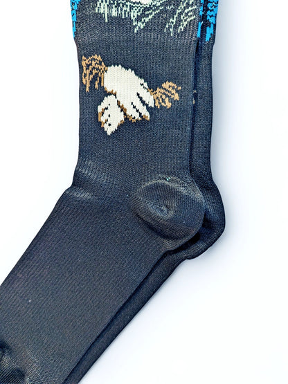 A pair of green Compression Socks, heel view