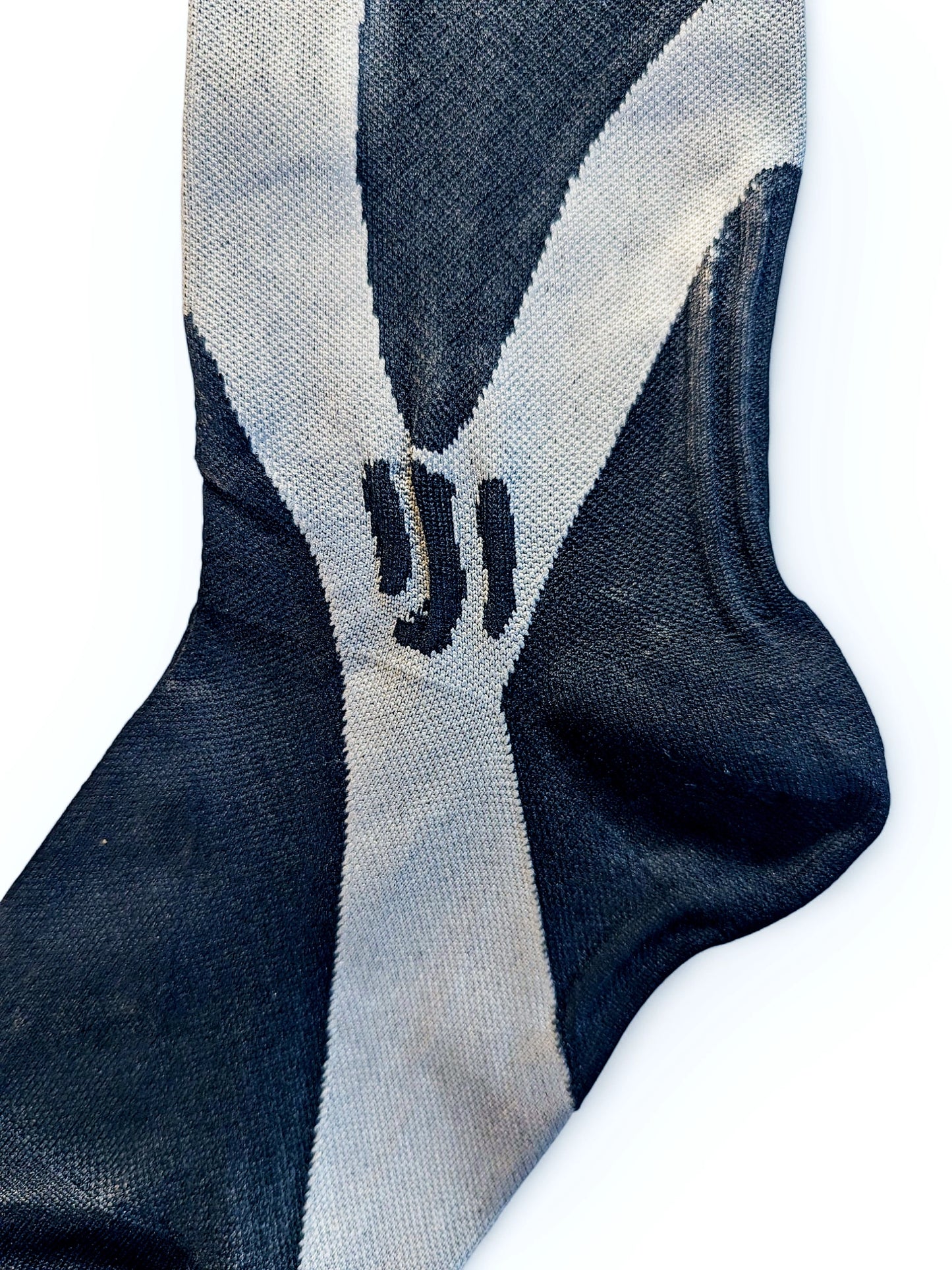 The heel of a pair of black sports compression socks