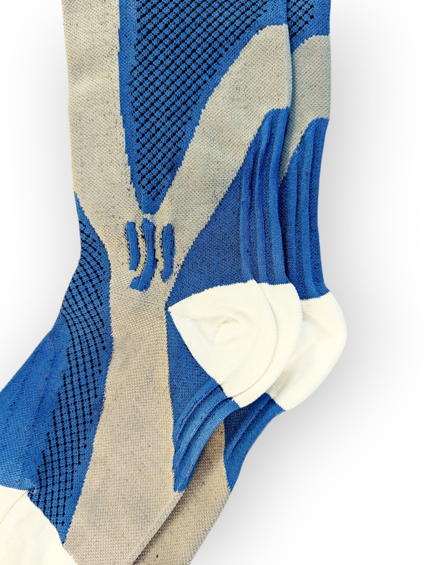 The heel of a pair of blue sports compression socks