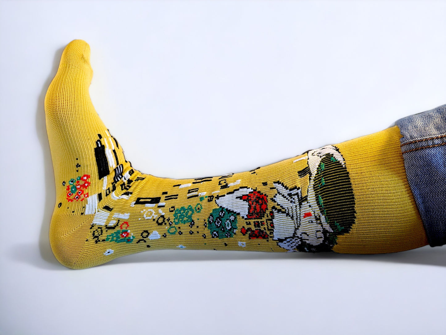 A leg wearing yellow compression socks with the famous painting 'Kiss' printed on it.