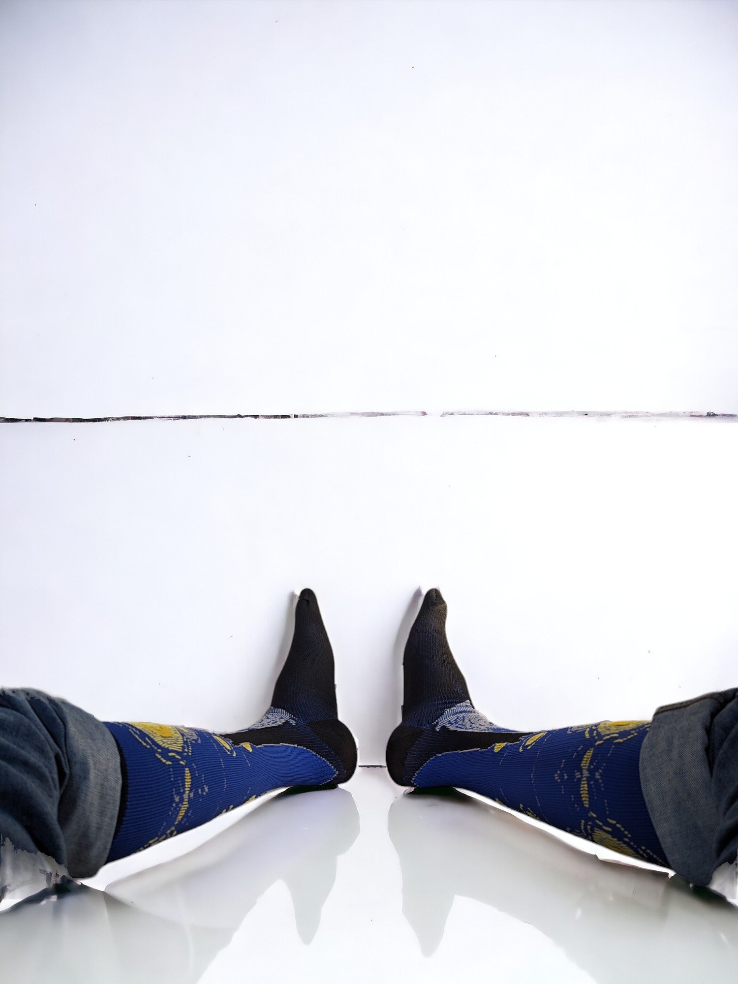 A pair of legs wearing blue compression socks