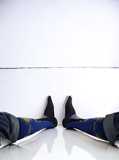 A pair of legs wearing blue compression socks