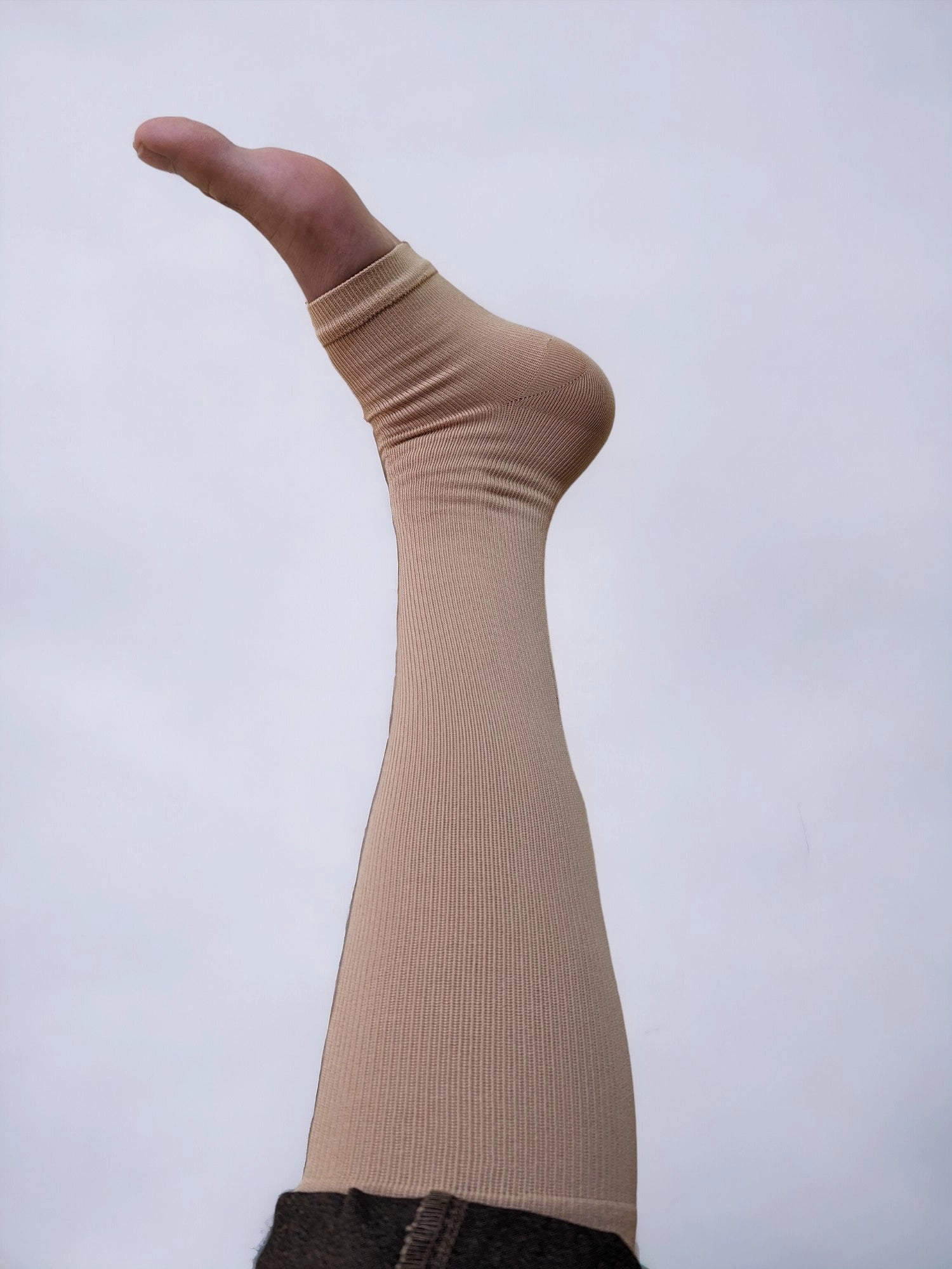 A leg wearing zippered compression socks.