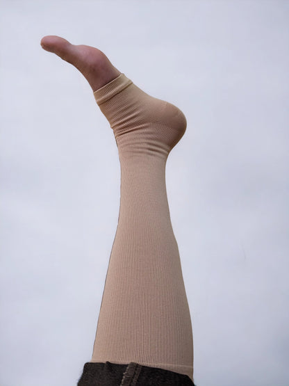 A leg wearing zippered compression socks.