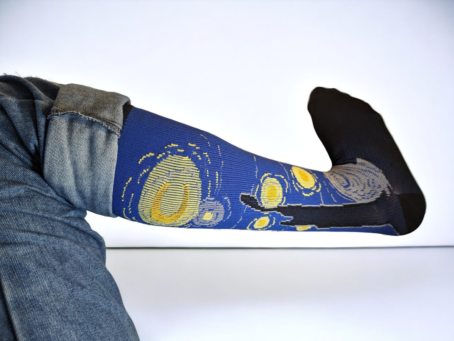 A leg wearing blue compression socks facing sideways