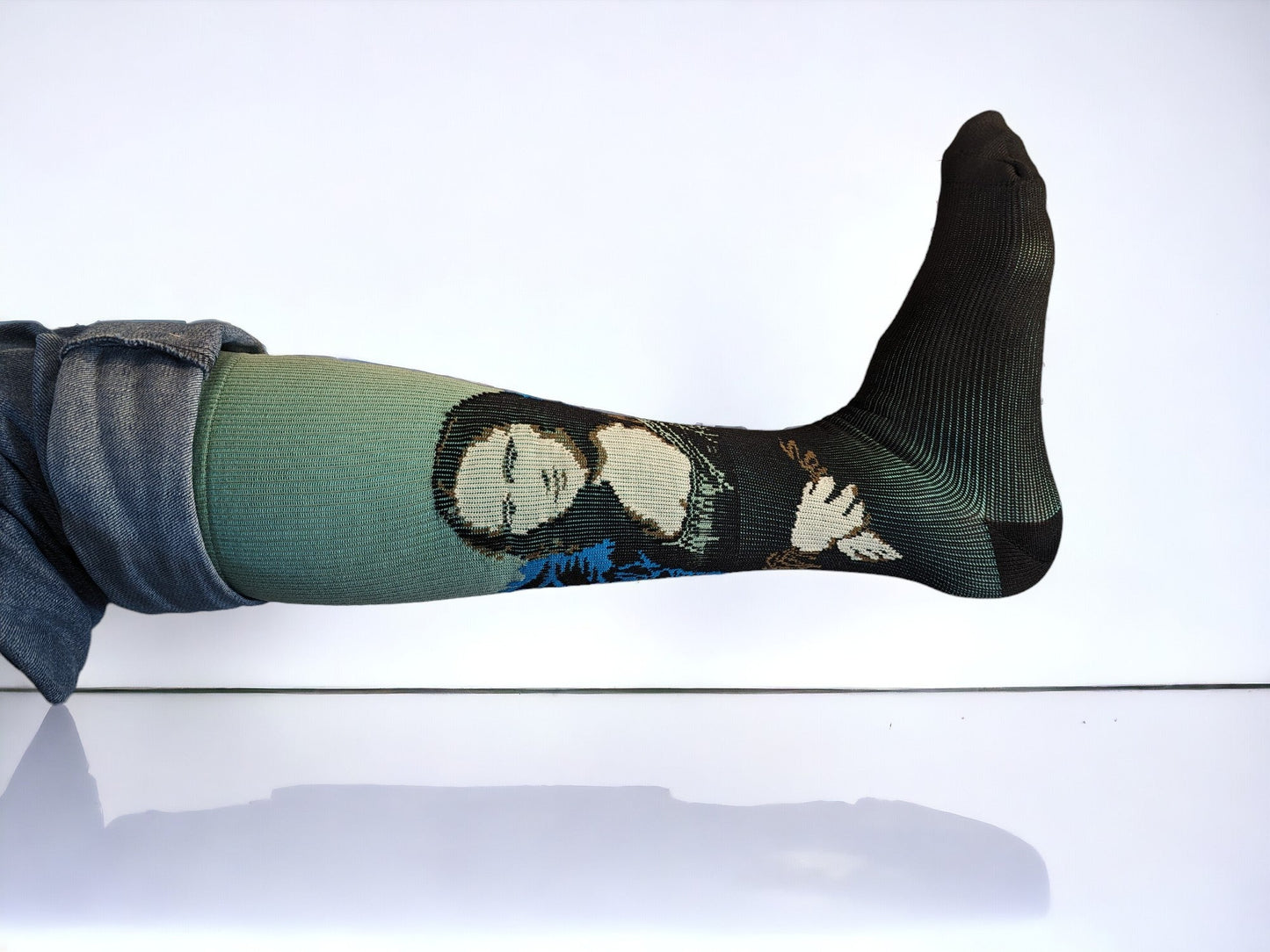 A leg wearing green compression socks facing sideways