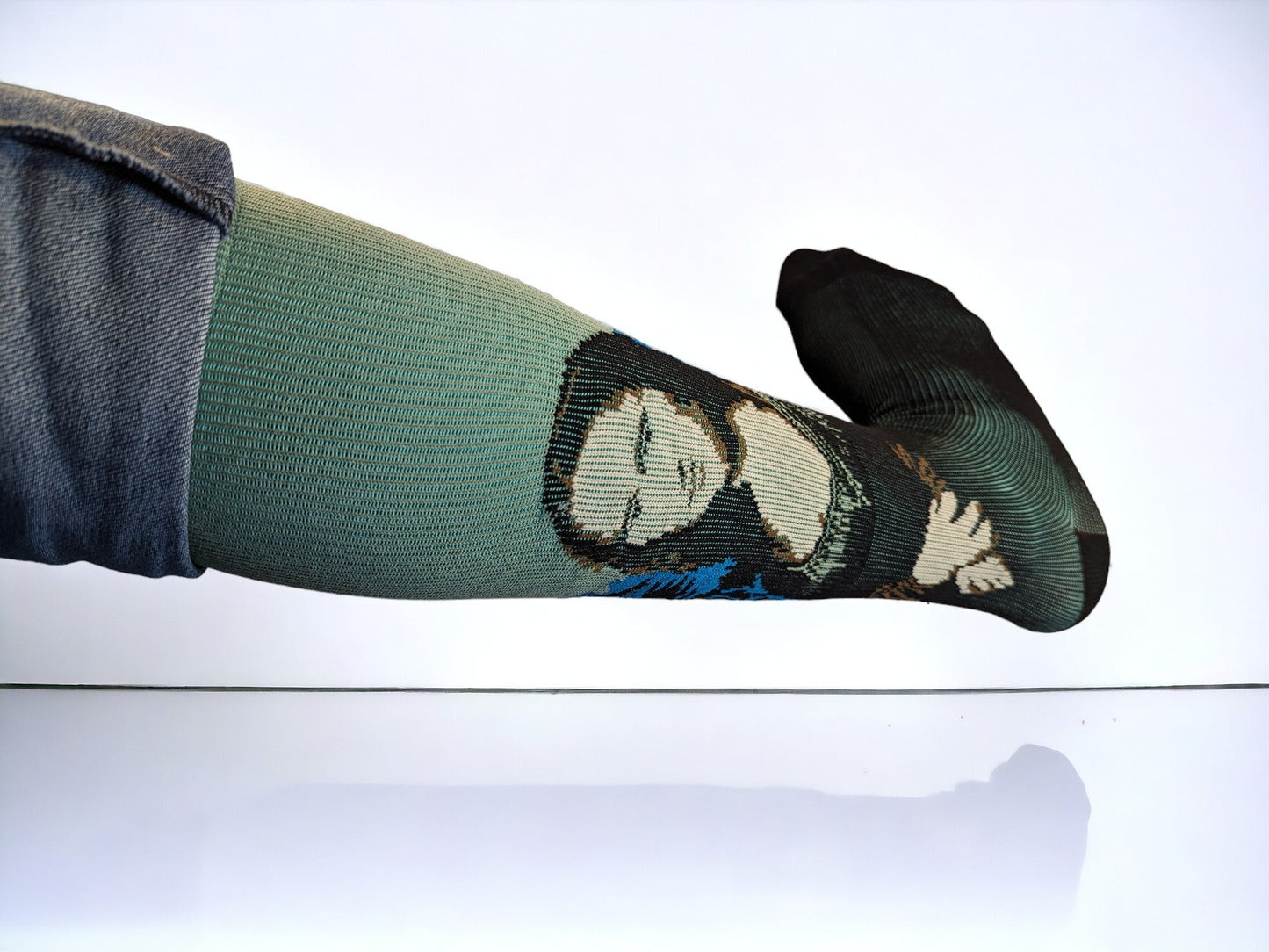 A leg wearing green compression socks facing sideways