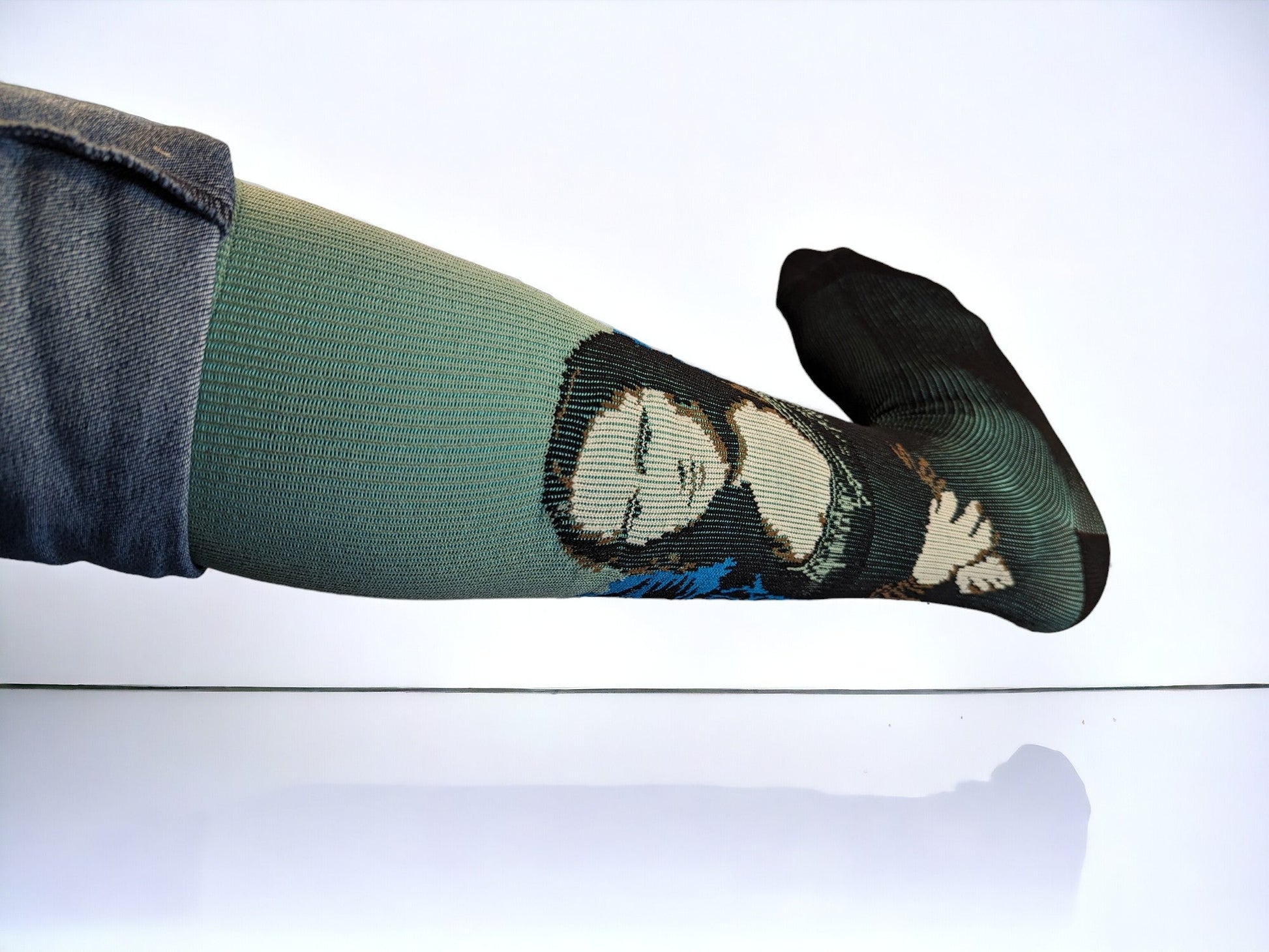 A leg wearing green compression socks facing sideways