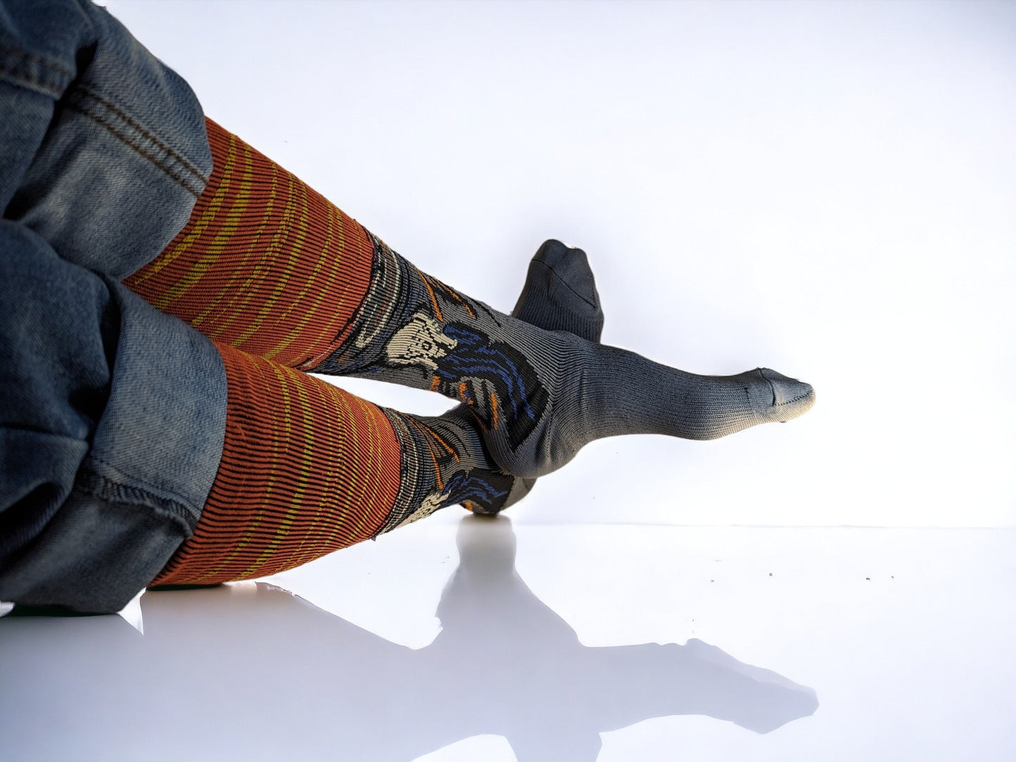 Two legs wearing orange compression socks lying sideways.
