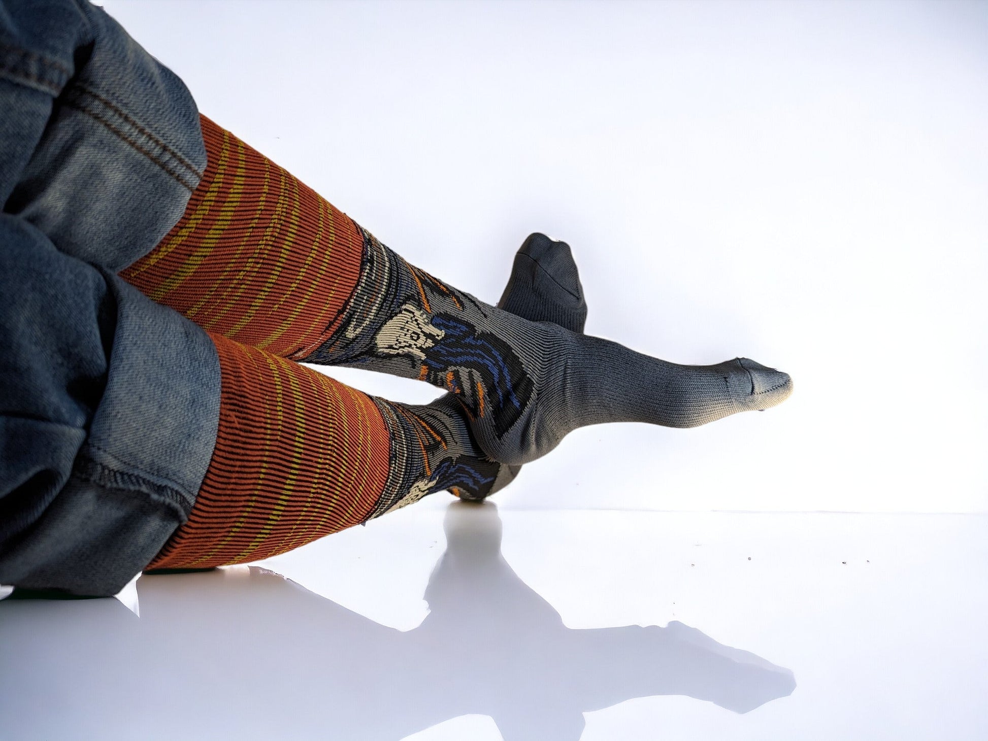 Two legs wearing orange compression socks lying sideways.