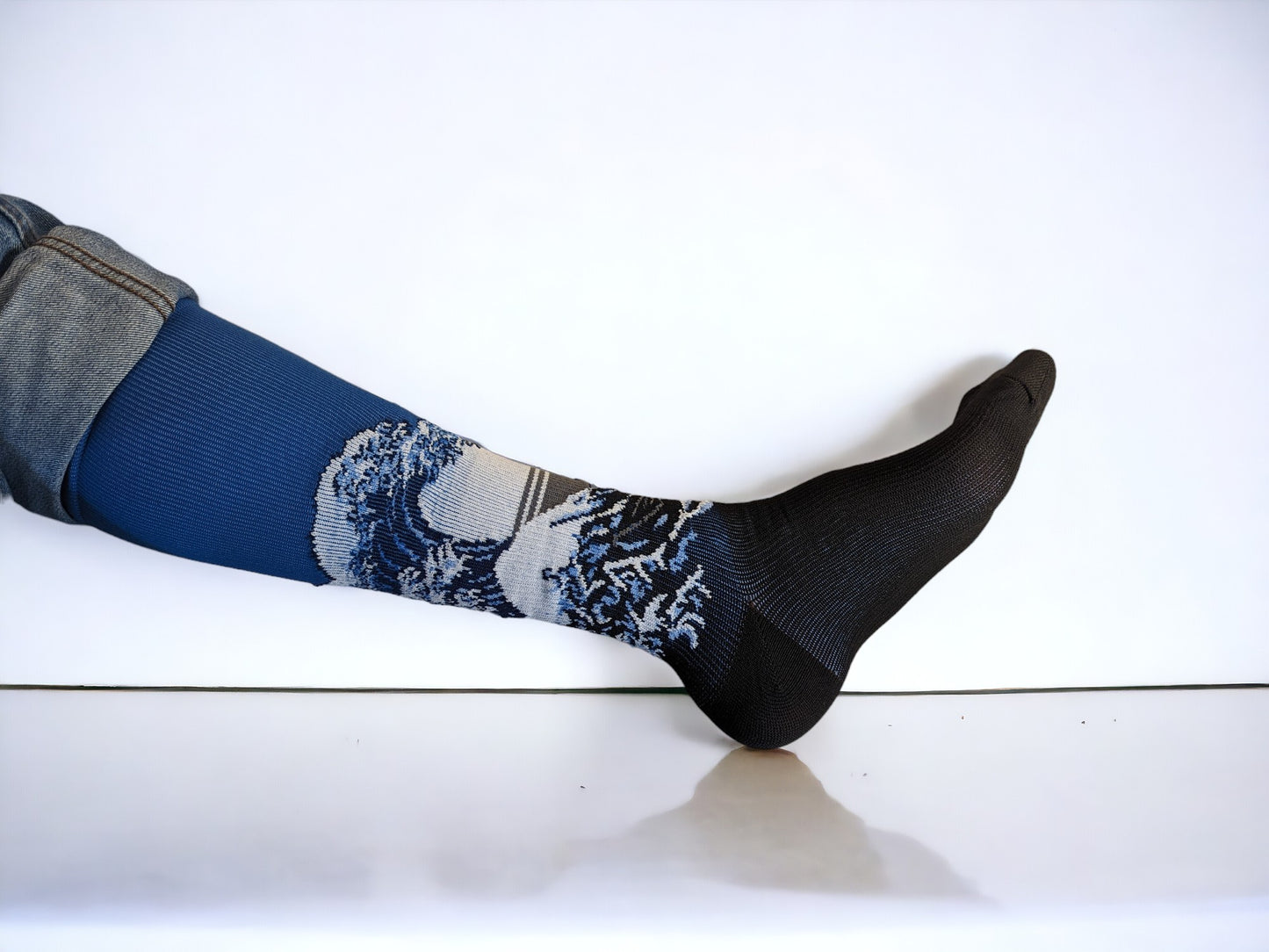 A leg wearing blue compression socks facing sideways