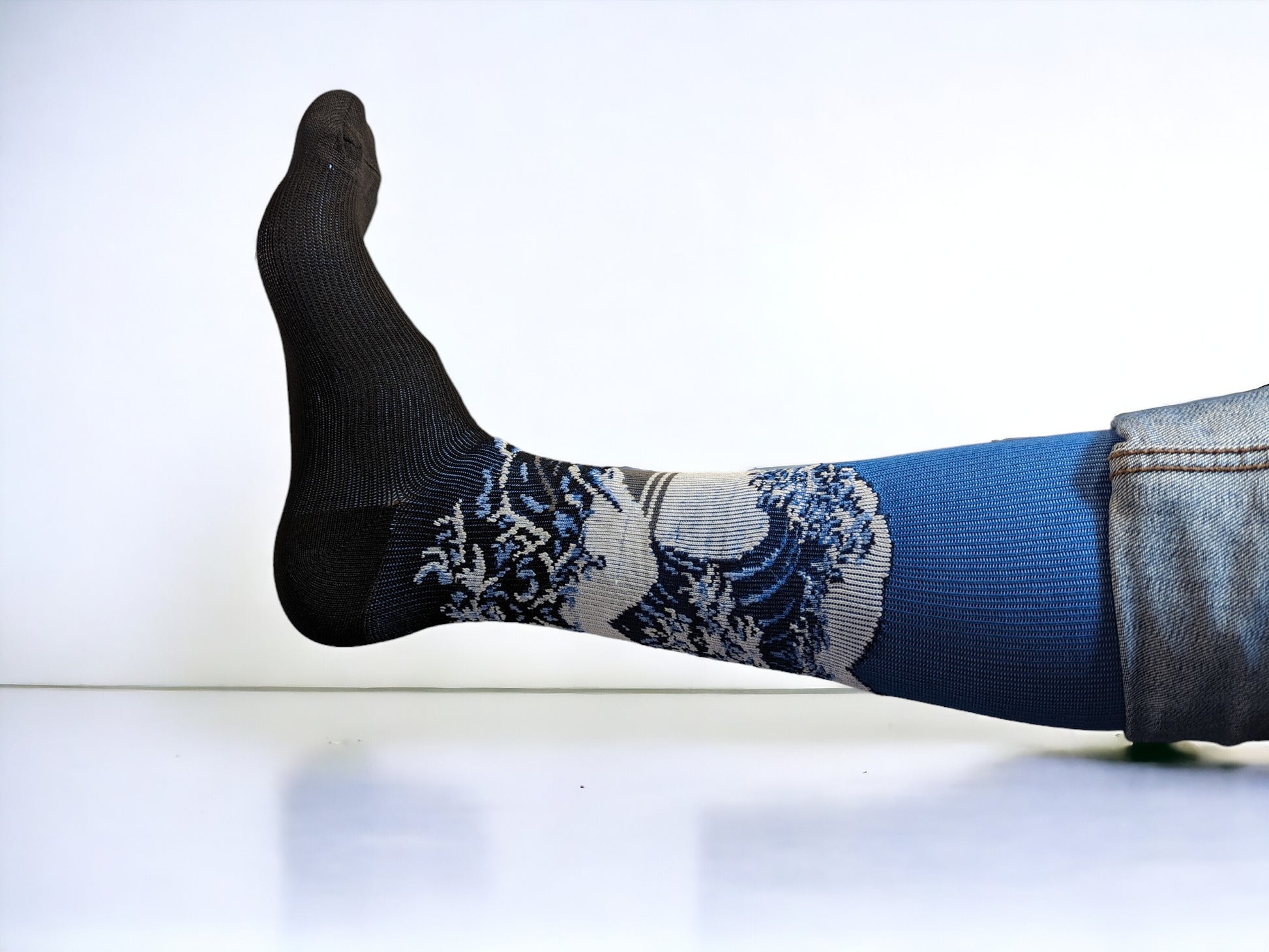 A leg wearing blue compression socks facing sideways