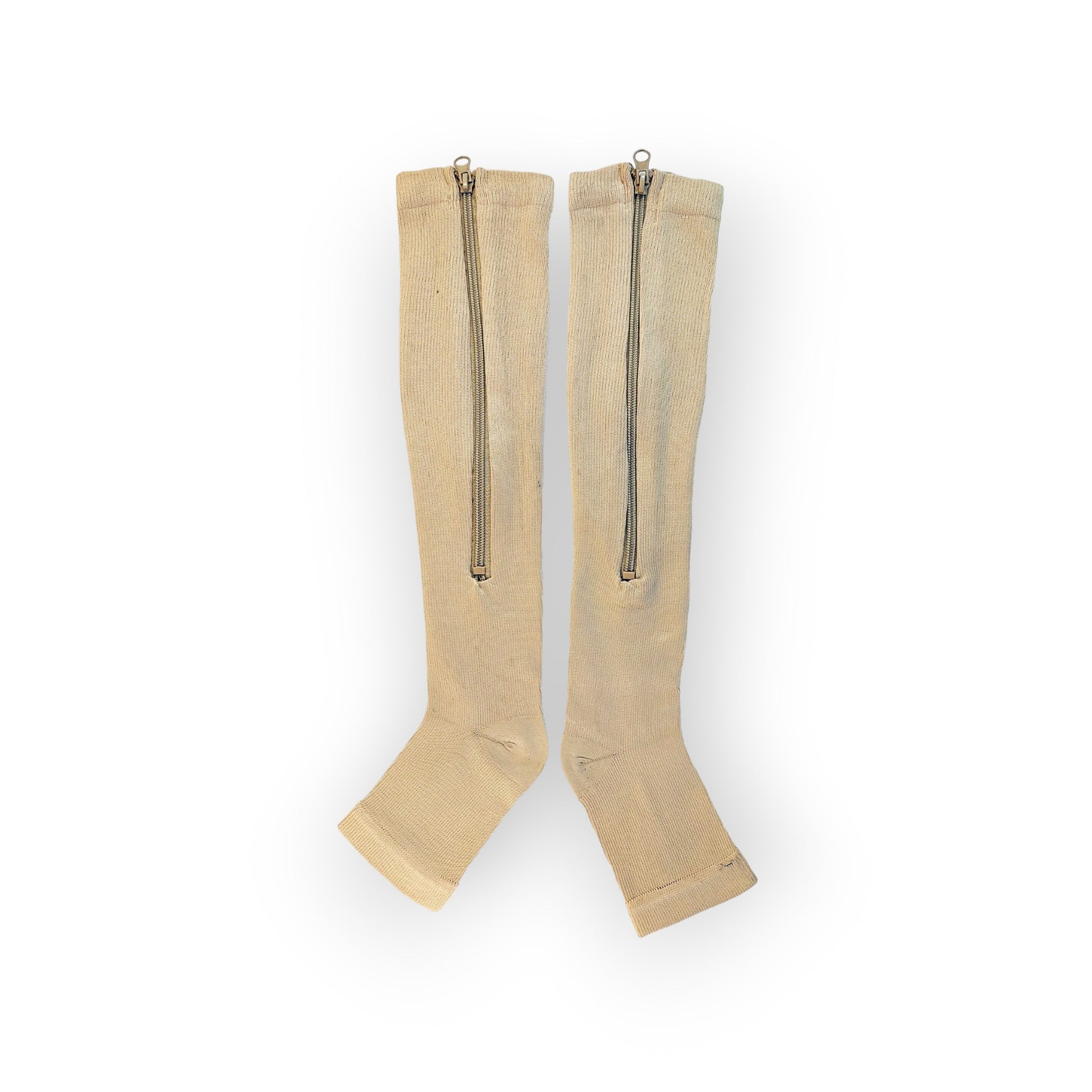 A pair of skin colored zippered knee-high compression socks