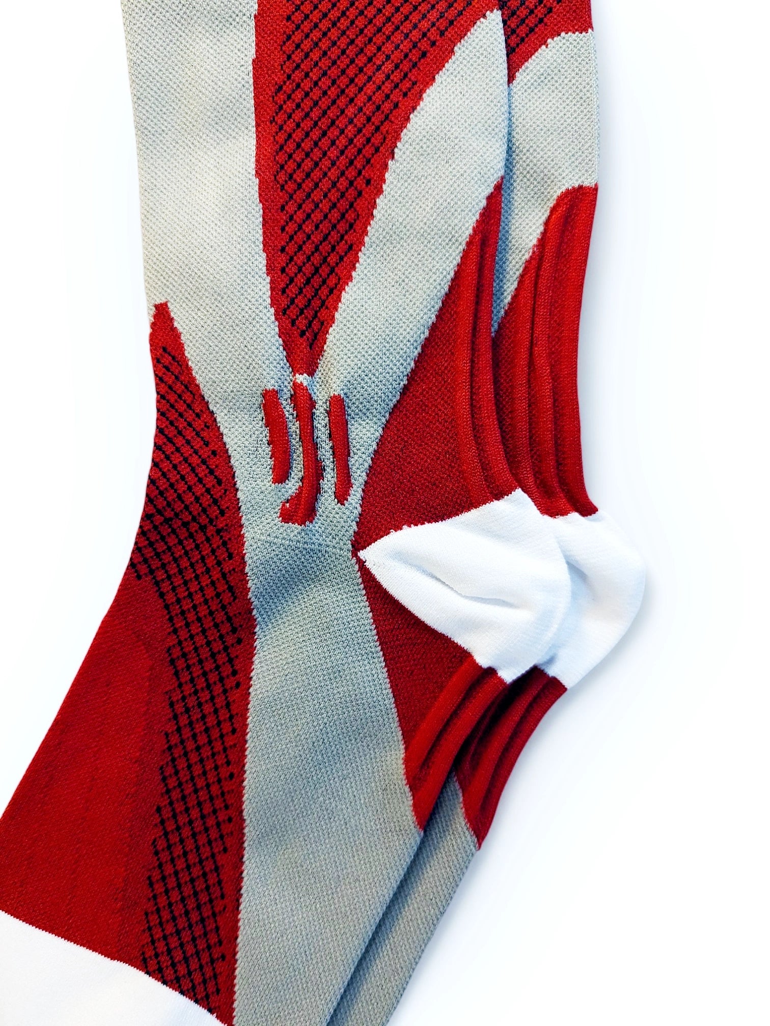 The heel of a pair of red sports compression socks