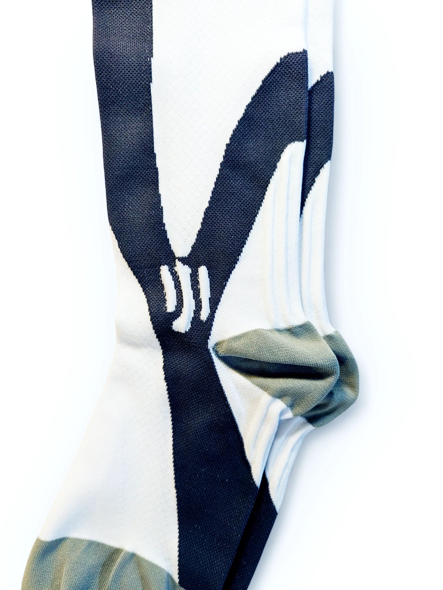 The heel of a pair of white sports compression socks