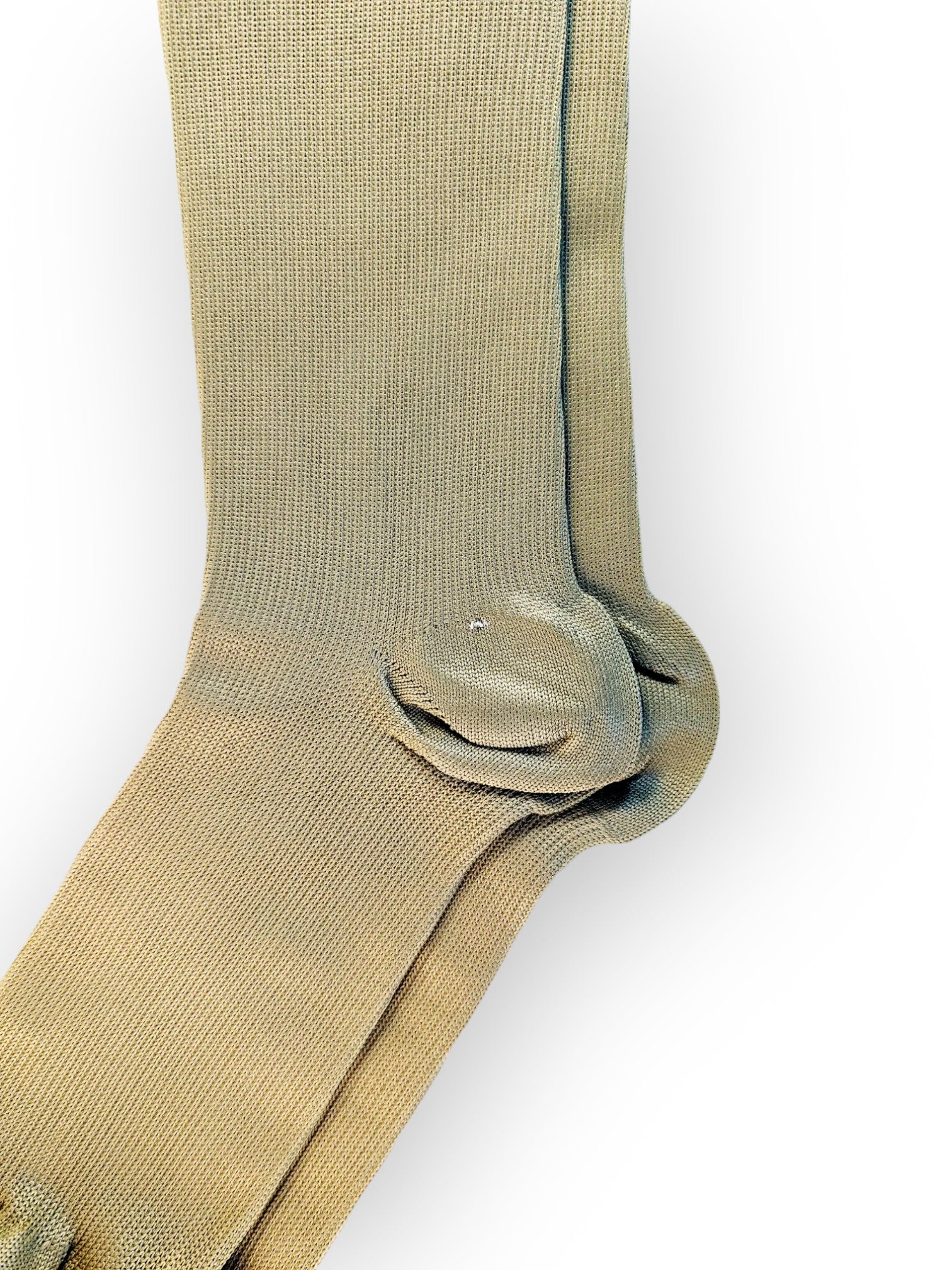 The heel part of a pair of skin-colored compression socks